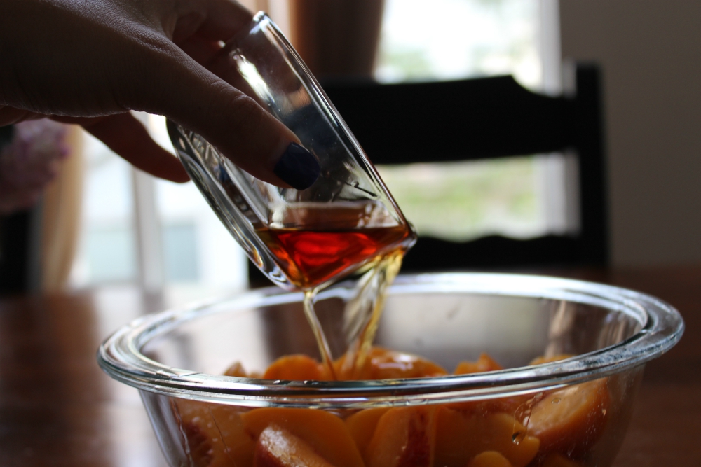 Peaches soaking in bourbon - Drunken Peach Crisp Recipe from Rocky Mtn Bliss.