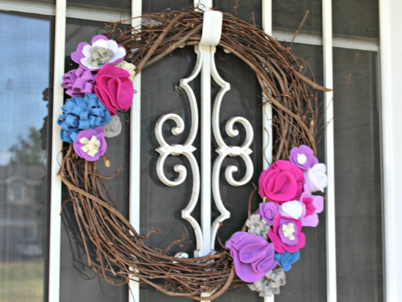Making a felt flower wreath is a fun and easy way to add some cheer to your door decor!